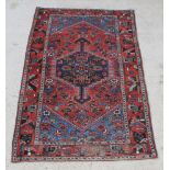 A red and blue ground Persian Toyserkan rug with central medallion 83" x 53" There are signs of wear