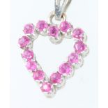 A 14ct white gold ruby set heart pendant 1.5 grams