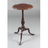 An Edwardian Chippendale style circular mahogany wine table raised on spiral turned column and