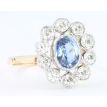 An 18ct yellow gold sapphire and diamond cluster ring, size O