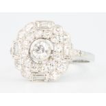 An 18ct white gold Edwardian style cluster ring with brilliant and baguette cut diamonds 1.25ct,