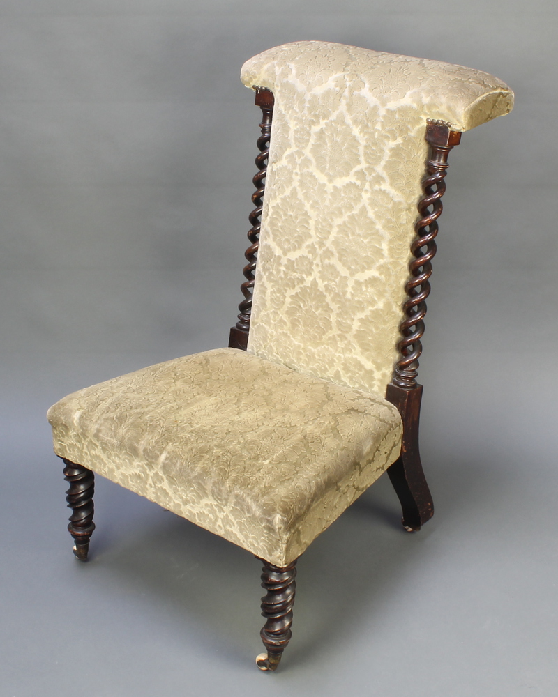 A Victorian mahogany prie-dieu chair with spiral turned columns to the sides, raised on spiral