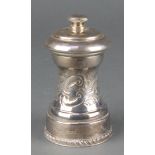 A repousse silver pepper mill with scroll decoration Birmingham 1973