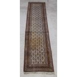 A white and green ground Sarough runner 129" x 31"There is flecking to the body and possibly sign of