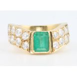 An 18ct baguette cut emerald and diamond ring size M