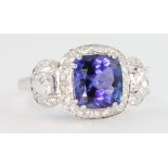 An 18ct white gold tanzanite and diamond ring, the centre stone approx 2.8ct flanked by baguette cut