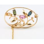 A 9ct yellow gold gem set open floral brooch