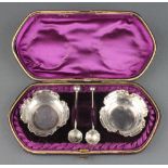 A pair of Victorian silver salts Birmingham 1887 in a fitted case with 2 odd spoons