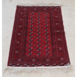 A red ground Bokhara rug with 36 octagons to the centre within multi-row borders 72" x 51"