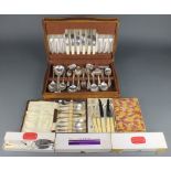 An oak canteen containing mixed silver plated cutlery, 5 cased sets