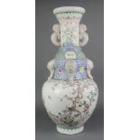 An 18th Century style Chinese famille rose vase with lion handles decorated with birds amongst
