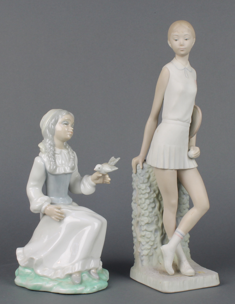 A matt Lladro figure of a lady tennis player 12 1/2" and a Continental figure of a girl with bird 8"