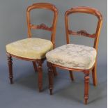 A pair of Victorian carved mahogany bar back chairs with carved mid rails and upholstered seats,