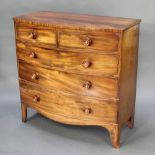 A 19th Century mahogany bow front chest of 2 short and 3 long drawers with tore handles, raised on