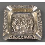 A Dutch repousse silver square ashtray decorated with an Inn scene 65 grams