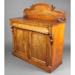 A Victorian mahogany chiffonier with raised shaped back, the base fitted a drawer above a cupboard