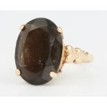 A 9ct yellow gold smokey quartz dress ring size J