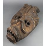 A carved African mask with articulated jaw 20"h x 12"w There are signs of old but treated worm and