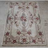 A cream ground and floral patterned Chinese rug 95" x 60" There is some staining to this carpet