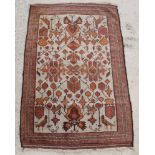 A white and brown ground Baluch rug with birds in vines 57" x 34" There are signs of wear and