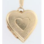 A 9ct yellow gold engine turned locket 3.1 grams