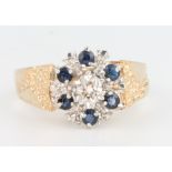 A 9ct yellow gold sapphire and diamond ring with fancy shank size N