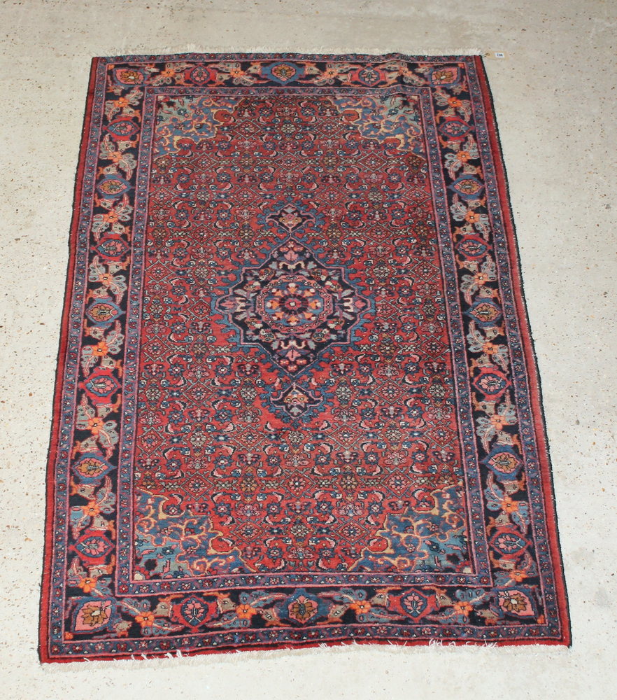 A Persian Bidjar red and blue ground rug with central medallion 79" x 52" There is some flecking