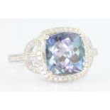 A 14ct white gold tanzanite and diamond ring, the cushion cut centre stone approx. 4ct surrounded by