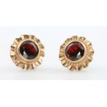 A pair of 9ct yellow gold garnet set ear studs