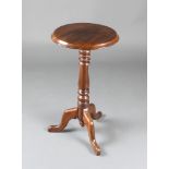 A Victorian circular mahogany wine table raised on pillar and tripod supports 28"h x 16" diam. There