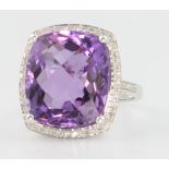 A white gold amethyst and diamond ring, the cushion shaped centre stone approx. 13.6ct surrounded by
