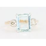 An 18ct yellow gold aquamarine and diamond ring, the centre stone approx. 2ct flanked by brilliant