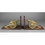 A pair of mahogany and brass book ends decorated canons 6" x 9 1/2" x 4 1/2"