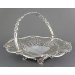 A Victorian silver swing handled basket with pierced decoration on scrolled feet Maker Henry