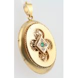 A Victorian gold pearl and emerald set locket