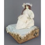 A 19th Century Continental automaton in the form of a bonneted seated girl with turning head and