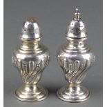 A pair of Edwardian silver repousse condiments Makers Farraday & Davey London 1906 3 1/4" 1 item has