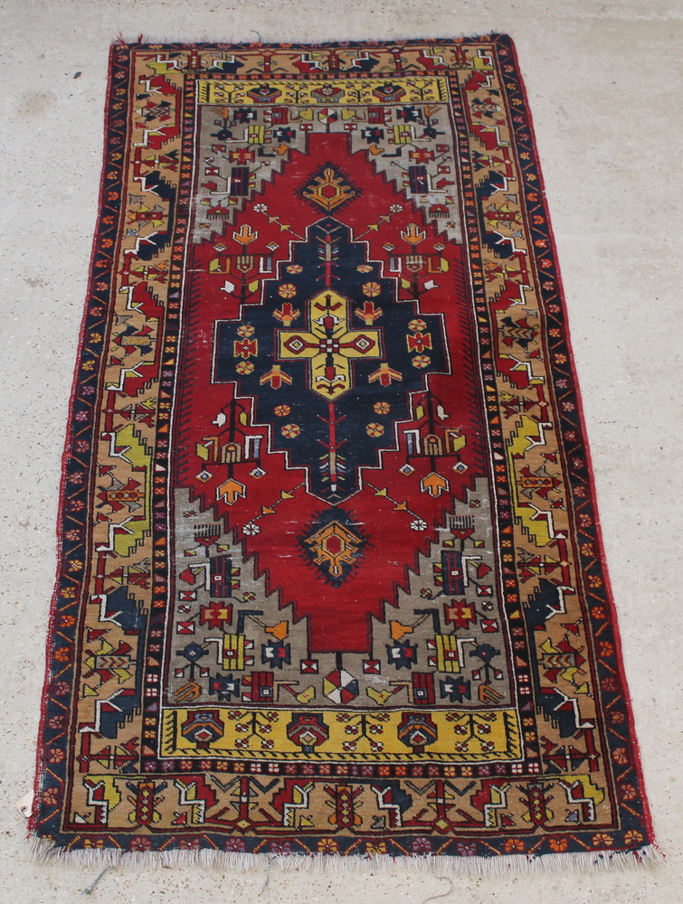 A yellow and blue ground Persian rug with central stylised medallion 100" x 48" This carpet shows