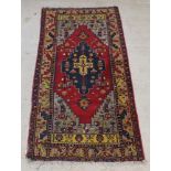 A yellow and blue ground Persian rug with central stylised medallion 100" x 48" This carpet shows