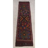 A multi-coloured Suzni runner with 5 rectangular panels to the centre 98" x 25"