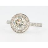 A platinum single stone diamond ring approx. 1.5ct surrounded by brilliant cut diamonds approx. 0.