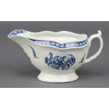 An 18th Century Worcester blue and white sauce boat with strap, fluted floral decoration 6" The