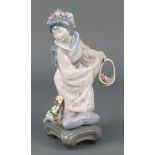 A Lladro figure of a Japanese lady holding a basket of flowers E7J 8 1/2" There are minor chips to