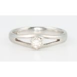 A platinum and diamond single stone ring with open shank size J