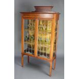 An Edwardian Art Nouveau inlaid mahogany display cabinet with raised back, fitted plush lined