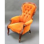 A Victorian mahogany show frame armchair upholstered in buttoned corderoy burnt orange material,