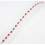 A silver red and and white cubic zirconia line bracelet