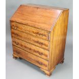 A Georgian style inlaid and crossbanded mahogany bureau, the fall front revealing a stepped interior