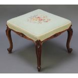 A Victorian carved rosewood square stool, the seat upholstered in Berlin woolwork raised on carved