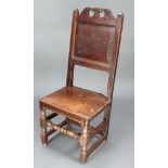 An 18th Century oak hall chair with solid seat and back raised on square supports with box framed